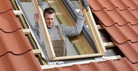 man installing window