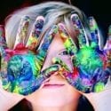 child with paint on hands