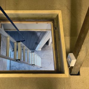 Loft hatch and ladder seen from above with light switch