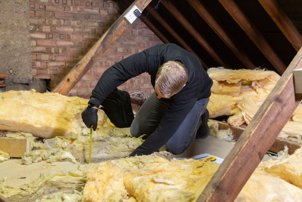surveyor inspecting loft insulation