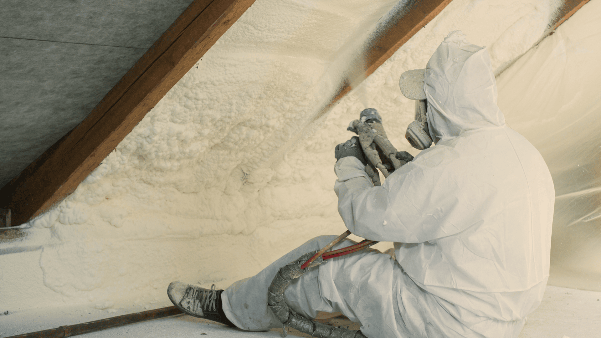 Spray foam being applied to the underside of a roof
